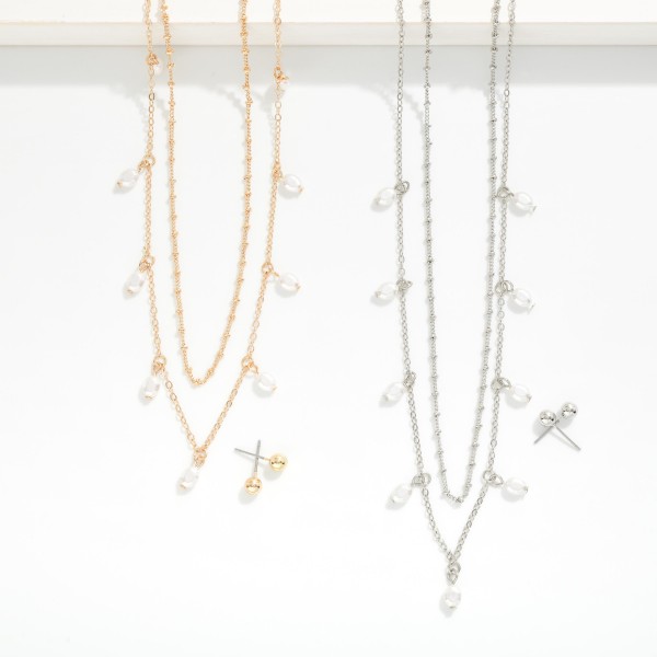 Layered Chain Link Necklace Featuring Pearl Charms 

- Metal Tone Ball Stud Earrings Included
- Approximately 16" L
- Extender 3" L