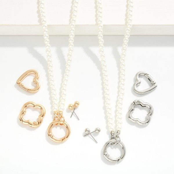 Pearl Beaded Necklace Featuring Interchangeable Metal Tone Clasp

- Includes 3 different clasps- circle, heart, & clover
- Gold Tone Ball Stud Earrings Included 
- Approximately 16" L
- Extender 3" L