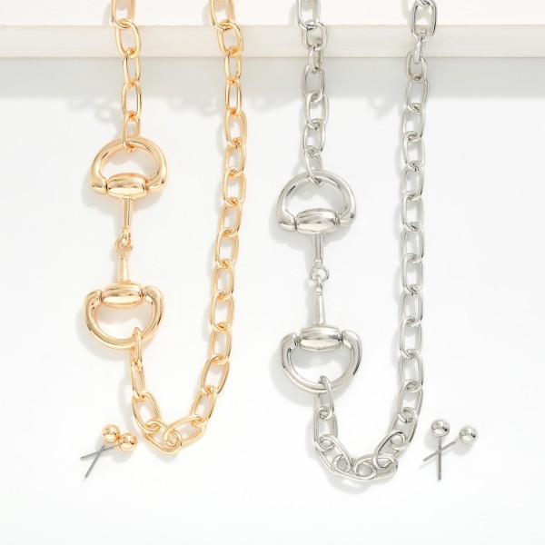Chain Link Necklace Featuring Metal Tone Horsebit Stationary Pendant 

- Metal Tone Ball Stud Earrings 
- Approximately 18" L
- Extender 3" L