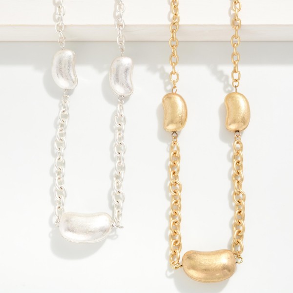 Long Chain Link Necklace Featuring Metal Tone Bean Stations 

- Approximately 36" L
- Extender 3" L