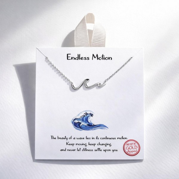 Dainty Chain Link Necklace Featuring Metal Tone Wave Stationary Pendant 

- Approximately 16" L
- Extender 2" L
- Hypoallergenic Brass Base
- 18K Gold Dipped
- Card: "The beauty of a wave lies in its continuous motion. Keep moving, keep changing, and never let stillness settle upon you."