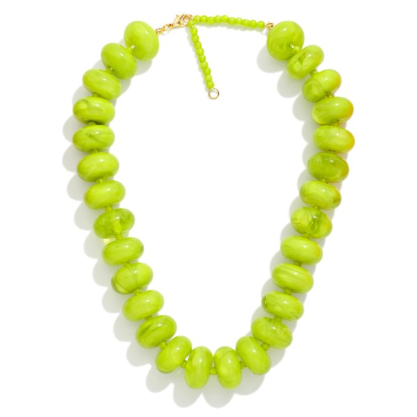 Chunky Rondelle Bead Necklace with oversized glossy beads finished by a slim seed bead strand at the back for comfortable wear. The bold, collar length silhouette makes a statement on its own over sweaters, tees, and simple dresses. A secure clasp keeps it in place all day. Statement bead necklaces like this are a fall favorite and an easy add on for customers building a complete look.