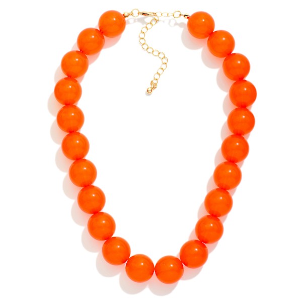 Chunky Round Bead Necklace strung with oversized glossy beads for a bold, polished statement. The smooth, uniform beads sit at the collarbone and pair perfectly with crew necks, button downs, and fall dresses. A lobster clasp and extender chain allow an easy, adjustable fit. Bold bead necklaces are a fall must have that boutiques can style on mannequins for an instant outfit upsell.