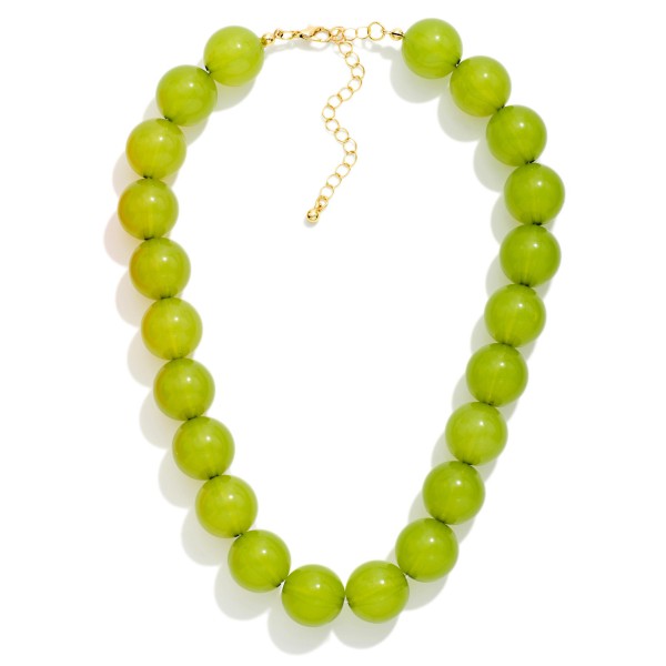 Chunky Round Bead Necklace strung with oversized glossy beads for a bold, polished statement. The smooth, uniform beads sit at the collarbone and pair perfectly with crew necks, button downs, and fall dresses. A lobster clasp and extender chain allow an easy, adjustable fit. Bold bead necklaces are a fall must have that boutiques can style on mannequins for an instant outfit upsell.