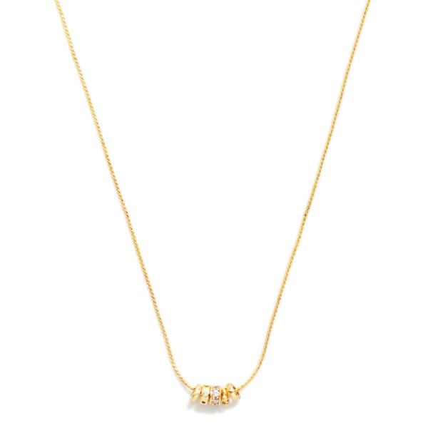 Dainty Snake Chain Necklace with a small cluster of polished metal rondelle beads that slide along the chain for a subtle, modern accent. The sleek, minimal design is perfect for everyday wear and layering. Wear it alone with a simple tee or stack it with pendants and longer chains. A versatile basic at an easy price that customers buy in multiples, making it a steady boutique seller.