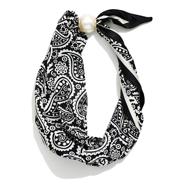 Paisley Print Scarf Necklace with a silky bandana style scarf knotted around a polished faux pearl accent. The classic paisley pattern brings a Western and boho feel that pairs perfectly with denim, sweaters, and fall jackets. No tying required, so it goes on in seconds for an instantly styled look. A trendy, affordable accessory that sells well on its own and as an easy add on for Western and boho boutiques.