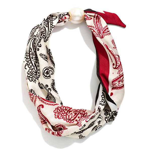 Paisley Print Scarf Necklace with a silky bandana style scarf knotted around a polished faux pearl accent. The classic paisley pattern brings a Western and boho feel that pairs perfectly with denim, sweaters, and fall jackets. No tying required, so it goes on in seconds for an instantly styled look. A trendy, affordable accessory that sells well on its own and as an easy add on for Western and boho boutiques.
