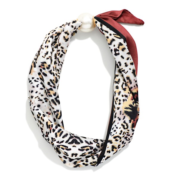 Printed Scarf Necklace with a silky scarf knotted into a playful bow and anchored by a polished faux pearl accent. The pre styled design adds instant charm to sweaters, blouses, jackets, and simple dresses. No tying required, so customers get a perfectly styled neckline in seconds. A fun, giftable accessory at an easy price point that stands out on any display and pairs well with pearl studs for an add on sale.