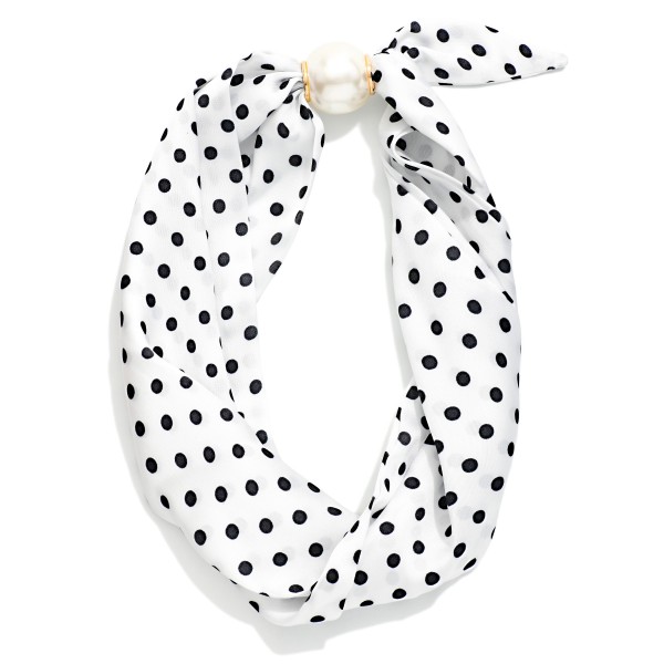 Printed Scarf Necklace with a silky scarf knotted into a playful bow and anchored by a polished faux pearl accent. The pre styled design adds instant charm to sweaters, blouses, jackets, and simple dresses. No tying required, so customers get a perfectly styled neckline in seconds. A fun, giftable accessory at an easy price point that stands out on any display and pairs well with pearl studs for an add on sale.