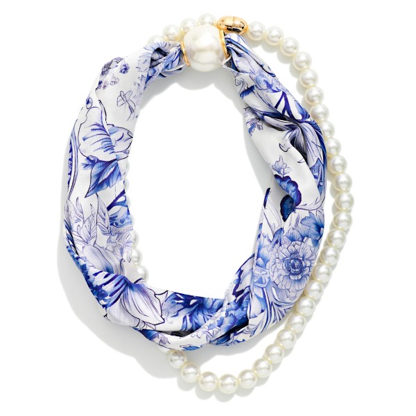 Floral Print Scarf Necklace that twists a silky printed scarf with a faux pearl strand and a polished pearl closure. The delicate floral print and classic pearls feel romantic and polished for brunch, church, or the office. Simply slip it on for an instantly styled neckline over sweaters and blouses. Scarf necklaces are an easy, eye catching gift idea that brings something different to any accessory display.