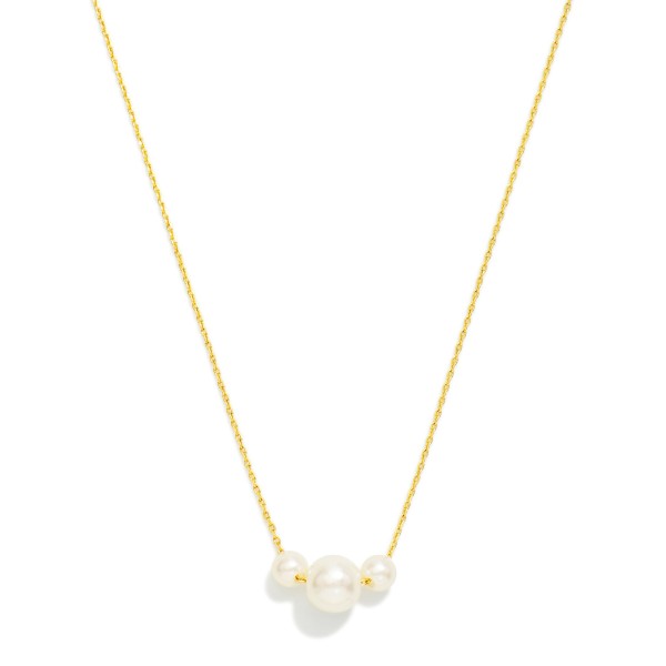 Floating Pearl Trio Necklace featuring three graduated faux pearls clustered at the center of a fine, dainty chain. The simple, balanced design adds soft luster to any neckline without overpowering, so it works with everything from tees to formal wear. A lovely pick for bridesmaid gifts, graduations, and Mother's Day. Classic pearl styles never go out of season, making this an easy, steady seller.