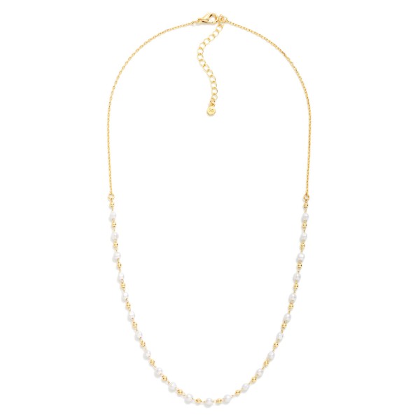 Pearl Station Necklace with a fine, dainty chain accented by petite faux pearls and tiny metal beads spaced along the front for a delicate, scattered look. An adjustable extender makes it easy to wear alone or layered with pendants and longer chains. A graceful choice for weddings, showers, graduations, and everyday polish. Lightweight and easy to gift, pearl layering pieces like this turn quickly in any boutique jewelry case.
