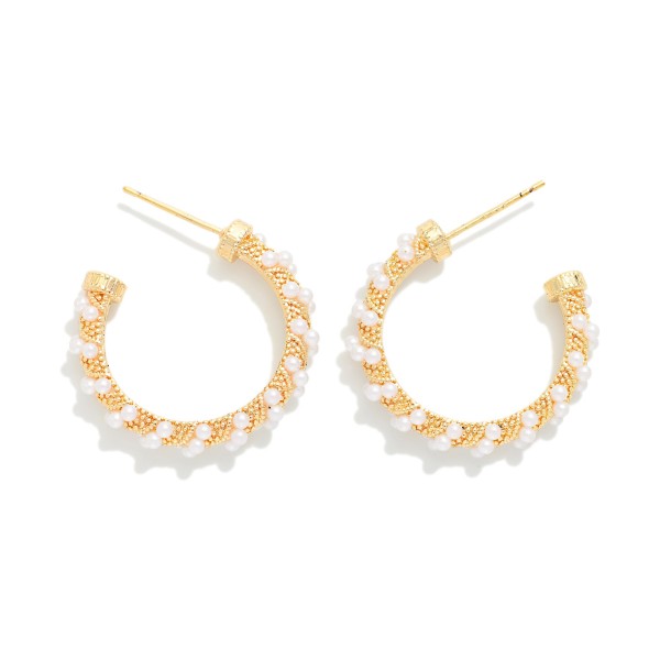Pearl Wrapped Open Hoop Earrings featuring a slim open hoop lined with petite faux pearls and tiny metal beads for soft, textured shine. Lightweight posts and an open front design keep them comfortable for all day wear. A polished, versatile style for brides, bridesmaids, office looks, and date nights alike. Pearls remain a top selling trend, and these timeless hoops make an easy gift any time of year.