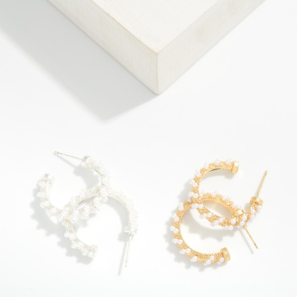 Pearl Wrapped Open Hoop Earrings featuring a slim open hoop lined with petite faux pearls and tiny metal beads for soft, textured shine. Lightweight posts and an open front design keep them comfortable for all day wear. A polished, versatile style for brides, bridesmaids, office looks, and date nights alike. Pearls remain a top selling trend, and these timeless hoops make an easy gift any time of year.
