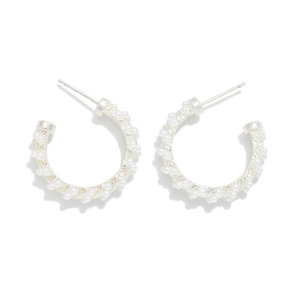 Pearl Wrapped Open Hoop Earrings featuring a slim open hoop lined with petite faux pearls and tiny metal beads for soft, textured shine. Lightweight posts and an open front design keep them comfortable for all day wear. A polished, versatile style for brides, bridesmaids, office looks, and date nights alike. Pearls remain a top selling trend, and these timeless hoops make an easy gift any time of year.