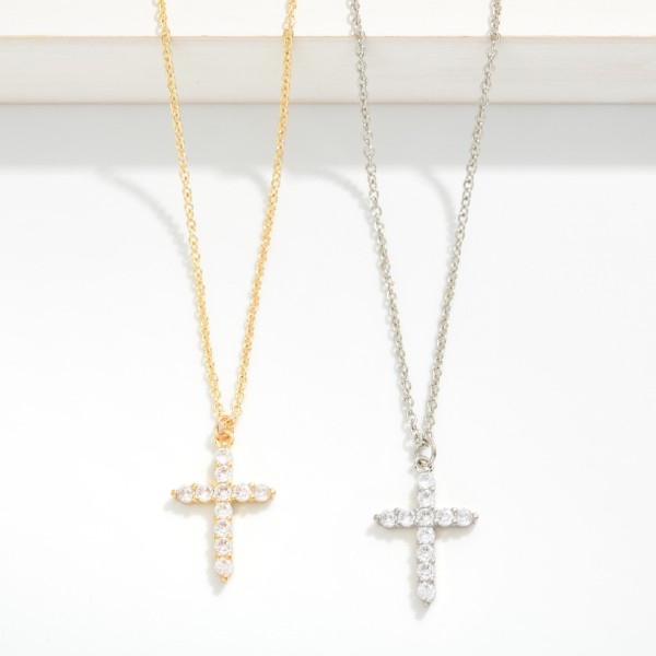 Cubic Zirconia Cross Pendant Necklace featuring a slender cross set end to end with sparkling round stones on a fine, dainty chain. The delicate scale makes it an easy everyday piece that layers beautifully with initials, charms, and longer chains. A meaningful gift for baptisms, confirmations, Easter, and Christmas. Timeless faith jewelry like this stays in steady demand year round, making it a dependable reorder for any boutique.