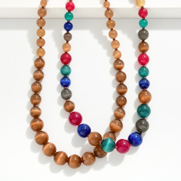 Graduated Bead Necklace with polished round stone look beads that grow in size toward the center for a classic, balanced drape. The glossy beads have a rich, natural shimmer, and the extender keeps the length adjustable. A timeless piece for church, the office, holiday gatherings and gifting. Classic beaded necklaces like this appeal to every age and sell steadily season after season.