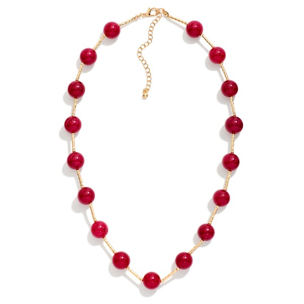 Stone Bead Station Necklace with polished round stone beads spaced along a dainty satellite chain. The organic stone patterns give every piece a natural, one of a kind look, and the extender keeps the length adjustable. Easy to layer with pendants or wear alone for everyday style. Earthy stone necklaces are a steady seller for boho and casual boutiques.