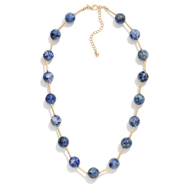 Stone Bead Station Necklace with polished round stone beads spaced along a dainty satellite chain. The organic stone patterns give every piece a natural, one of a kind look, and the extender keeps the length adjustable. Easy to layer with pendants or wear alone for everyday style. Earthy stone necklaces are a steady seller for boho and casual boutiques.