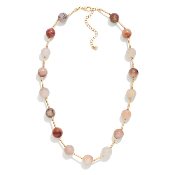 Stone Bead Station Necklace with polished round stone beads spaced along a dainty satellite chain. The organic stone patterns give every piece a natural, one of a kind look, and the extender keeps the length adjustable. Easy to layer with pendants or wear alone for everyday style. Earthy stone necklaces are a steady seller for boho and casual boutiques.