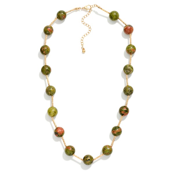Stone Bead Station Necklace with polished round stone beads spaced along a dainty satellite chain. The organic stone patterns give every piece a natural, one of a kind look, and the extender keeps the length adjustable. Easy to layer with pendants or wear alone for everyday style. Earthy stone necklaces are a steady seller for boho and casual boutiques.