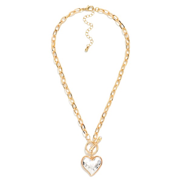 Two Tone Heart Pendant Necklace with a hammered puffy heart in a contrasting metal finish, hung from a front toggle on a polished cable chain. The dimensional heart catches the light from every angle, and the extender makes the length easy to adjust. A sweet pick for Valentine's Day, Galentine's gifts, Mother's Day and everyday wear. Heart styles sell all year, and this mixed metal version goes with everything.