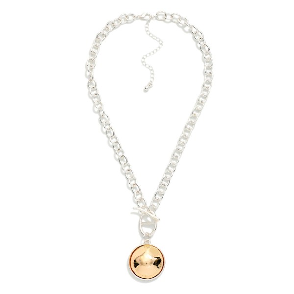 Two Tone Dome Pendant Necklace with a polished round medallion framed in a contrasting metal bezel, hung from a front toggle on a chunky rolo chain. The bold chain and smooth dome strike the right balance between statement and everyday, with an extender to adjust the length. Easy to style with sweaters, tees and dresses all season. Mixed metal pieces like this are a quick sell for boutiques at a friendly price.