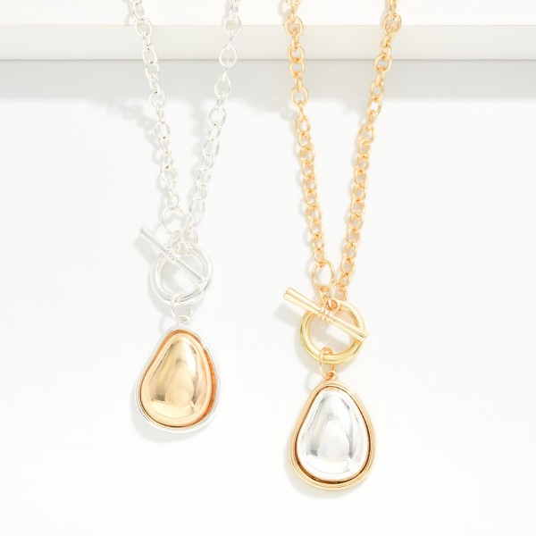 Two Tone Teardrop Pendant Necklace with a polished domed drop framed in a contrasting metal bezel, hung from a front toggle on a textured cable chain. The mixed metal look pairs easily with any jewelry already in her collection, and the extender adjusts the length. A clean everyday piece for workwear, weekends and gifting. Mixed metal styles are a top request, and this one comes in at an easy price.