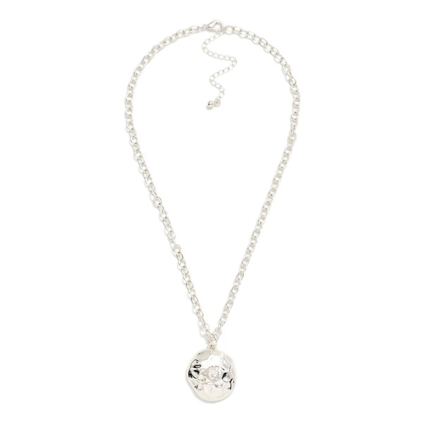 Hammered Disc Pendant Necklace with a polished coin charm set with a sparkling crystal accent on a classic rolo chain. The organic hammered texture catches the light from every angle, and the extender makes the length easy to adjust. A simple everyday layering piece that works for gifting, workwear and weekends. An easy price point that turns browsers into buyers at the jewelry wall.