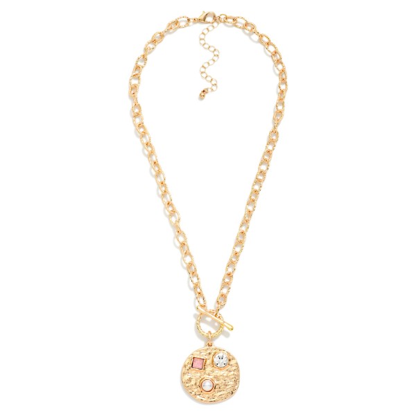 Toggle Medallion Necklace with a hammered coin pendant studded with crystal and stone accents, hung from a front toggle on a textured rolo chain. The organic hammered finish feels artisan and works with everything from denim to dresses, with an extender for easy sizing. A versatile everyday piece for gifting, travel and weekend style. Coin and toggle details are trending, and this one hits both at an easy price point.