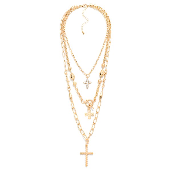 Layered Cross Necklace with three strands: a dainty chain with a rhinestone cross, a beaded chain with a toggle accent and cross charm, and a paperclip chain finished with a pave cross pendant. Already layered for an effortless stacked look that drapes from the collarbone to mid chest, with an extender for easy sizing. A meaningful gift for Christmas, Easter, baptisms, confirmations and Mother's Day. Faith pieces sell steadily year round, and the stacked style makes an easy add on at the counter.