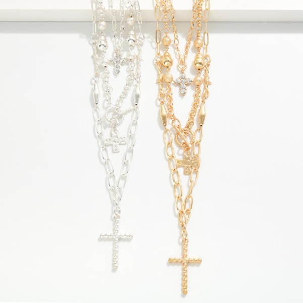 Layered Cross Necklace with three strands: a dainty chain with a rhinestone cross, a beaded chain with a toggle accent and cross charm, and a paperclip chain finished with a pave cross pendant. Already layered for an effortless stacked look that drapes from the collarbone to mid chest, with an extender for easy sizing. A meaningful gift for Christmas, Easter, baptisms, confirmations and Mother's Day. Faith pieces sell steadily year round, and the stacked style makes an easy add on at the counter.