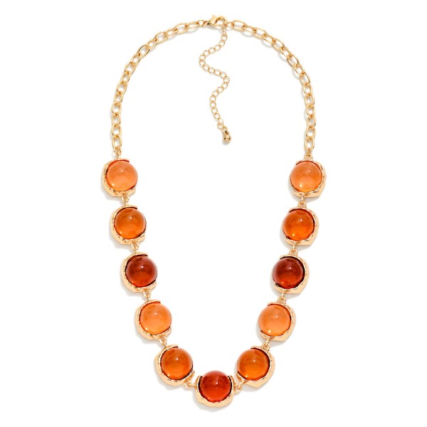 Oval Stone Statement Necklace with glossy domed cabochon stones framed in smooth metal bezels along a chunky link chain. The polished stones catch the light like sea glass and sit just below the collarbone, with an extender for easy sizing. Elegant enough for holiday parties and weddings, easy enough to wear with a cardigan on a weekday. A refined statement style that rounds out any boutique jewelry display.