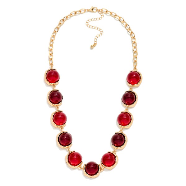 Oval Stone Statement Necklace with glossy domed cabochon stones framed in smooth metal bezels along a chunky link chain. The polished stones catch the light like sea glass and sit just below the collarbone, with an extender for easy sizing. Elegant enough for holiday parties and weddings, easy enough to wear with a cardigan on a weekday. A refined statement style that rounds out any boutique jewelry display.