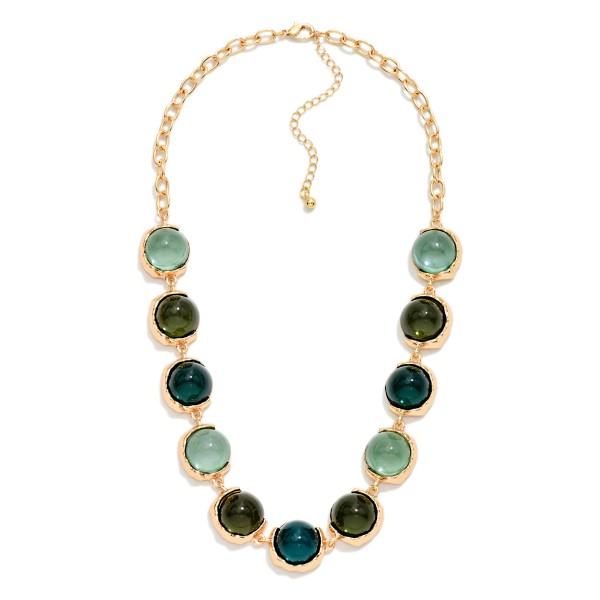 Oval Stone Statement Necklace with glossy domed cabochon stones framed in smooth metal bezels along a chunky link chain. The polished stones catch the light like sea glass and sit just below the collarbone, with an extender for easy sizing. Elegant enough for holiday parties and weddings, easy enough to wear with a cardigan on a weekday. A refined statement style that rounds out any boutique jewelry display.