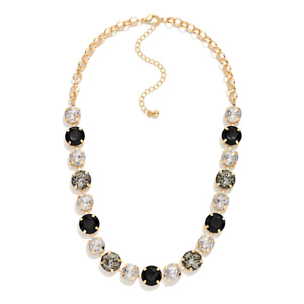 Crystal Statement Necklace with round faceted stones set in polished bezels and alternated with sparkling rhinestone accents on a classic link chain. It sits at the collarbone with an adjustable extender, so it frames any neckline from crew to V neck. A favorite for holiday parties, weddings, date nights and dressing up a simple sweater. Bold sparkle at an easy price point makes it a reliable seller for any boutique jewelry wall.