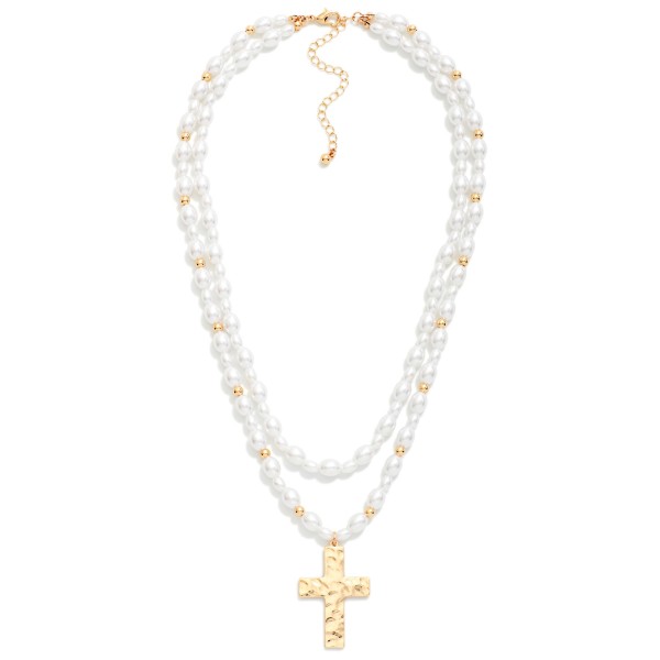 Layered Pearl Cross Necklace featuring two strands of faux pearls with polished metal bead accents and a textured cross pendant. The built in layering gives a finished, stacked look in one easy piece. Finished with a lobster clasp and extender. A graceful faith gift for baptisms, first communions, Easter, and Mother's Day that sells beautifully year round.