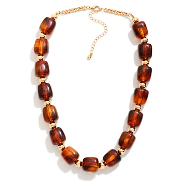 Chunky Resin Bead Necklace strung with polished barrel shaped beads spaced by small metal accents, finished with an adjustable chain extender. The marbled resin finish has the rich look of stone without the weight, so it sits comfortably at the collarbone all day. Pair it with crew neck sweaters, button downs, or simple dresses. Statement resin pieces are a strong seller for fall, and this style offers an elevated look at an easy price point.