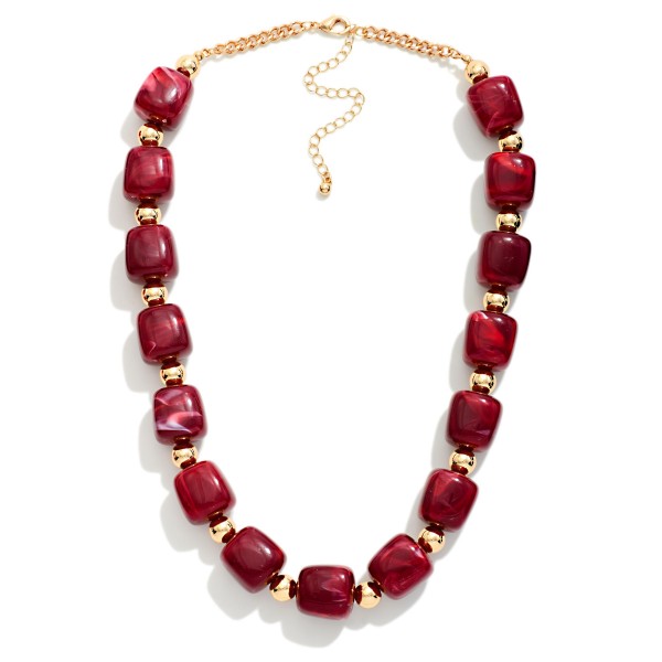 Chunky Resin Bead Necklace strung with polished barrel shaped beads spaced by small metal accents, finished with an adjustable chain extender. The marbled resin finish has the rich look of stone without the weight, so it sits comfortably at the collarbone all day. Pair it with crew neck sweaters, button downs, or simple dresses. Statement resin pieces are a strong seller for fall, and this style offers an elevated look at an easy price point.
