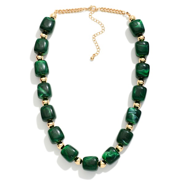 Chunky Resin Bead Necklace strung with polished barrel shaped beads spaced by small metal accents, finished with an adjustable chain extender. The marbled resin finish has the rich look of stone without the weight, so it sits comfortably at the collarbone all day. Pair it with crew neck sweaters, button downs, or simple dresses. Statement resin pieces are a strong seller for fall, and this style offers an elevated look at an easy price point.