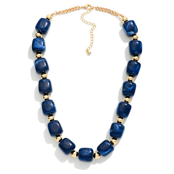 Chunky Resin Bead Necklace strung with polished barrel shaped beads spaced by small metal accents, finished with an adjustable chain extender. The marbled resin finish has the rich look of stone without the weight, so it sits comfortably at the collarbone all day. Pair it with crew neck sweaters, button downs, or simple dresses. Statement resin pieces are a strong seller for fall, and this style offers an elevated look at an easy price point.