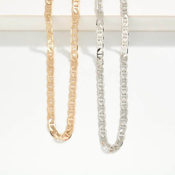 Flat Link Chain Necklace featuring a sleek, shimmering chain with flat, interlocking links that reflect the light. The polished finish feels elevated while staying easy to wear every day. Lobster clasp closure with an extender chain. A versatile layering chain that pairs with pendants or stands alone for a clean, modern look.