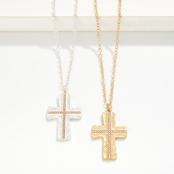 Textured Cross Pendant Necklace with a hammered cross pendant accented by a beaded inlay in a contrasting metal tone. The mixed metal detail adds depth and makes the piece easy to wear with any jewelry collection. Finished on a fine chain with a lobster clasp and extender. A thoughtful faith gift for baptisms, Easter, and Christmas, and a reliable year round seller for boutiques.