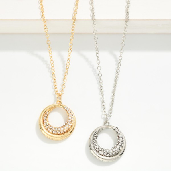Pave Circle Pendant Necklace featuring an open ring pendant with a crescent of sparkling rhinestones. The glint of crystal adds just enough shine for everyday wear, special occasions, and holiday parties. Suspended on a fine chain with a lobster clasp and extender. A timeless circle design that makes an easy gift for birthdays, anniversaries, and bridesmaids.
