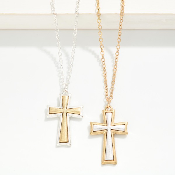 Mixed Metal Cross Pendant Necklace with a framed cross pendant featuring a contrasting brushed metal inlay. The mixed metal finish makes it easy to pair with any jewelry a customer already owns. Hung on a fine chain with a lobster clasp and extender. A meaningful everyday piece and a natural gift for baptisms, confirmations, Mother's Day, and the holidays.