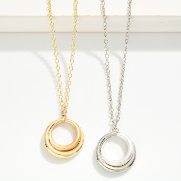 Organic Circle Pendant Necklace with a sculptural open ring pendant that has a soft, molten shape. Hung on a fine chain with a lobster clasp and extender, it adds subtle polish to everyday outfits. The minimalist design layers well with chokers and longer chains. A simple, modern piece at an easy price point that works as a self purchase or a thoughtful gift for any occasion.