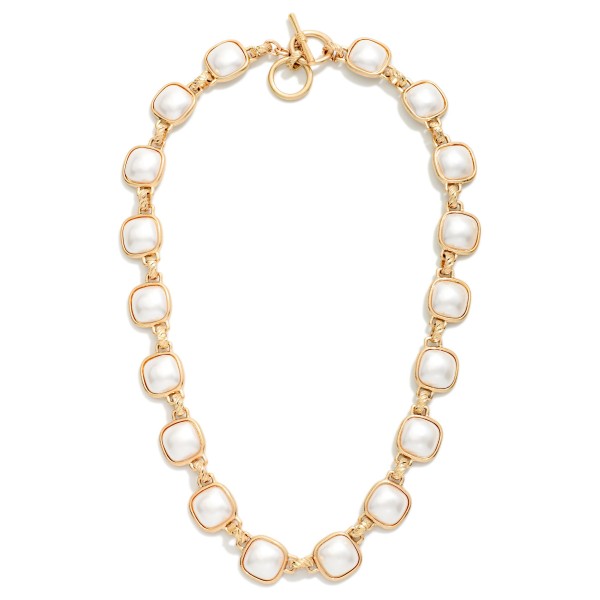 Pearl Station Toggle Necklace featuring round faux pearls set in polished bezels and linked together for a refined collar length look. A front toggle closure adds a modern touch to a classic pearl style. Elegant enough for weddings, showers, and church yet easy to wear with a simple sweater or tee. Pearls are a perennial bestseller, and this updated design appeals to both classic and trend focused customers.