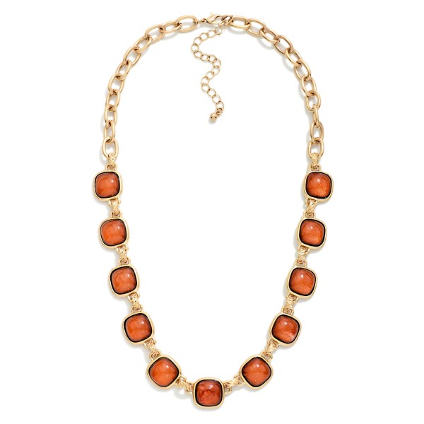 Square Stone Station Necklace featuring glossy square cabochon stones set in framed bezels and linked along a bold collar length chain. The rich stones give it a vintage inspired, heirloom feel that instantly elevates sweaters, button downs, and holiday dresses. Finished with a lobster clasp and extender chain. A statement piece at an accessible price, ideal for holiday parties, gifting, and boutique window displays.