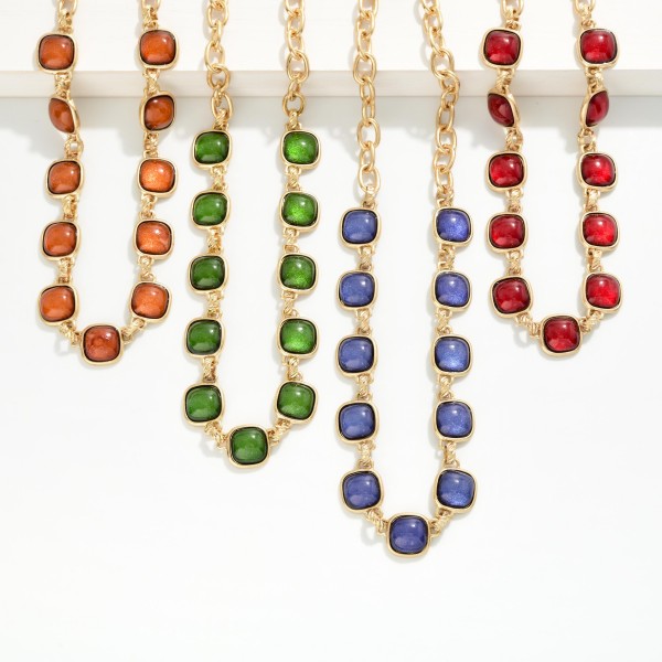 Square Stone Station Necklace featuring glossy square cabochon stones set in framed bezels and linked along a bold collar length chain. The rich stones give it a vintage inspired, heirloom feel that instantly elevates sweaters, button downs, and holiday dresses. Finished with a lobster clasp and extender chain. A statement piece at an accessible price, ideal for holiday parties, gifting, and boutique window displays.