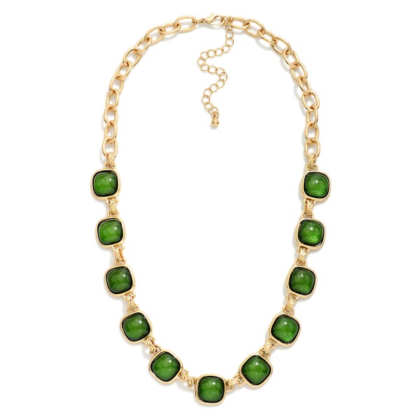 Square Stone Station Necklace featuring glossy square cabochon stones set in framed bezels and linked along a bold collar length chain. The rich stones give it a vintage inspired, heirloom feel that instantly elevates sweaters, button downs, and holiday dresses. Finished with a lobster clasp and extender chain. A statement piece at an accessible price, ideal for holiday parties, gifting, and boutique window displays.